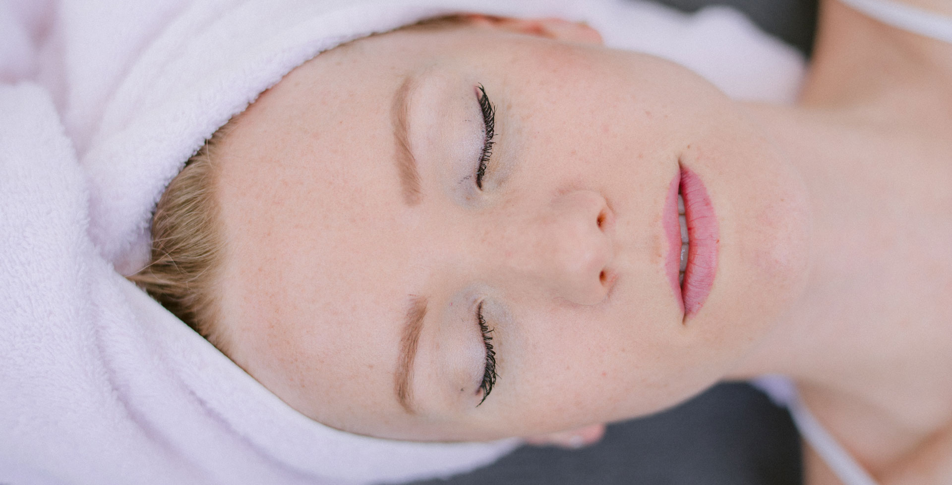 Client relaxing during a facial at our Hicksville day spa